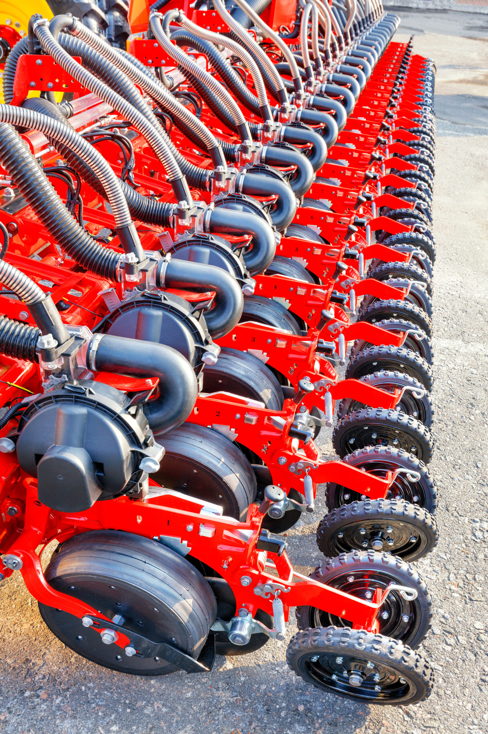 Red modern seeder, working mechanisms of a multi-row modern pneumatic agricultural seeder.